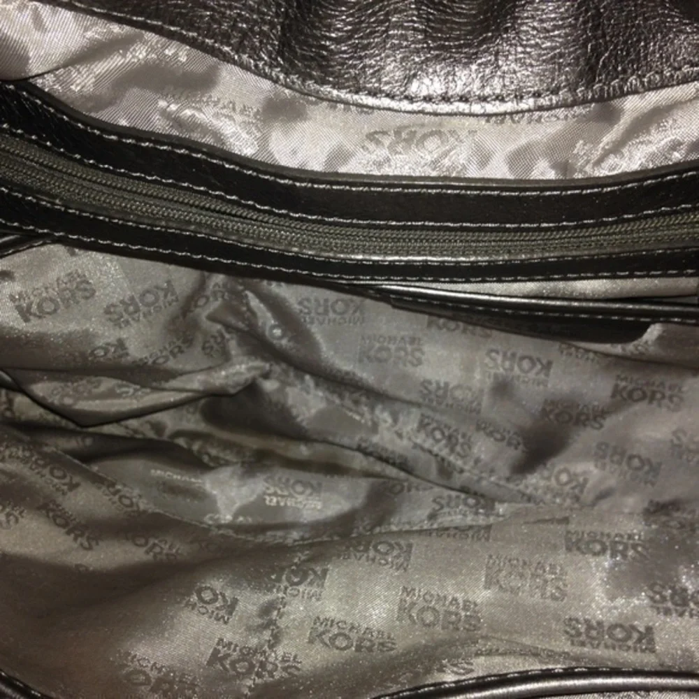 Michael Kors silver metallic hobo bag buckle
